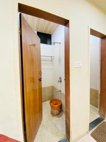 an open door to a bathroom with a toilet at Vishwa Heritage Ellora in Ellora