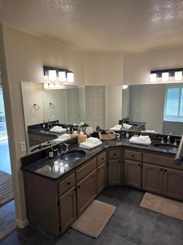 a bathroom with two sinks and a large mirror at Spacious Ranch Retreat Near Yosemite & Bass Lake with Hot Tub & Game Room in Oakhurst