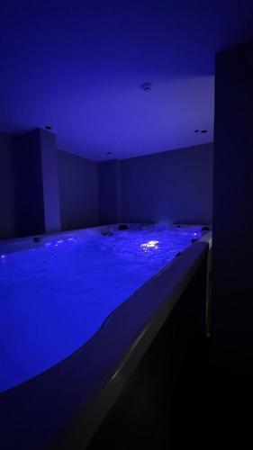 a dark room with a bed with blue lighting at فندق منسي Monsi Hotel in Taif