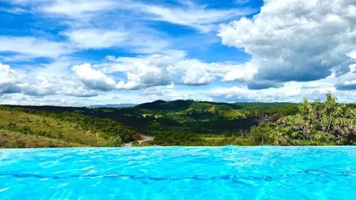 a view of a large pool of blue water at Hotel Mirante São Brás in São Brás do Suaçuí