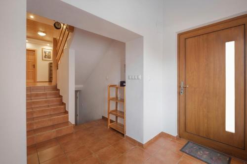 a hallway with a wooden door and stairs at Tatry TOP Dom in Vavrišovo