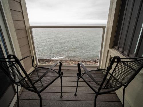 two chairs on a balcony with a view of the ocean at Beacon Pointe on Lake Superior in Duluth