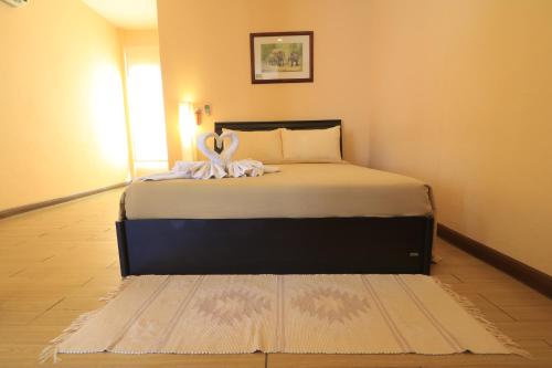 a bedroom with a bed with two swans on it at Baiyoke Chalet Hotel in Mae Hong Son