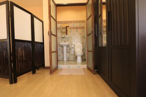 a bathroom with a toilet and a sink at Baiyoke Chalet Hotel in Mae Hong Son