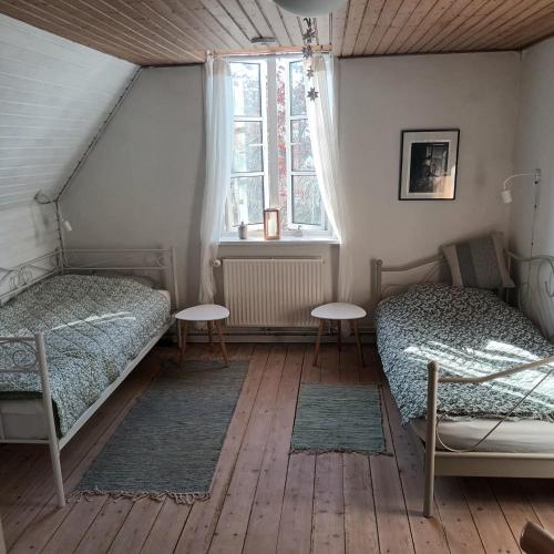 ein Schlafzimmer mit zwei Betten und einem Fenster in der Unterkunft Hestegården in Fåborg