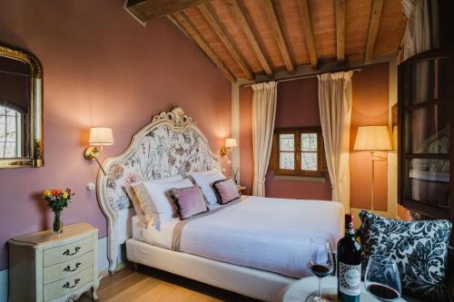 a bedroom with a white bed with purple walls at Residenza Il Colle in Impruneta