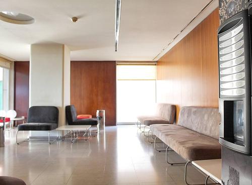 a living room with a couch and chairs and a table at Arrábida Luxury Studio in Vila Nova de Gaia