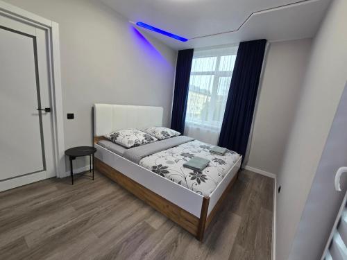 a small bedroom with a bed and a window at Svobody 5 in Uzhhorod