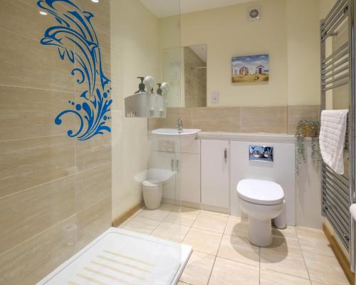 a bathroom with a toilet and a sink at 6 The Salterns - Yarmouth in Freshwater
