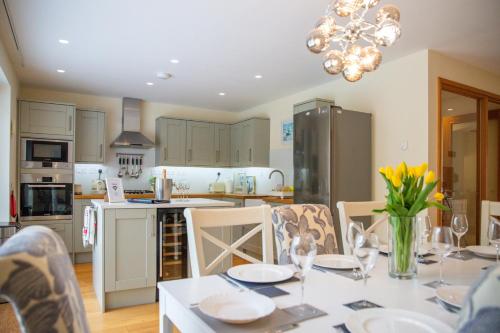 a kitchen with a table with chairs and a dining room at 6 The Salterns - Yarmouth in Freshwater