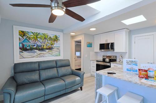 a living room with a couch and a kitchen at The Inn on Siesta Key in Siesta Key