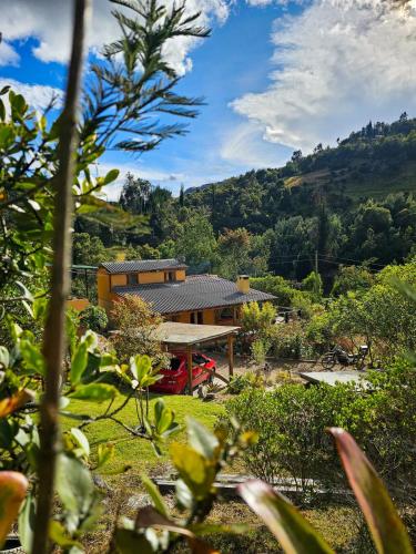 a house in the middle of a field at Cabaña Bachué in Sutatausa