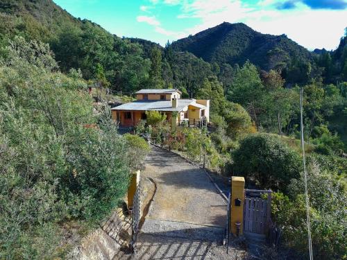 a house on the side of a mountain at Cabaña Bachué in Sutatausa