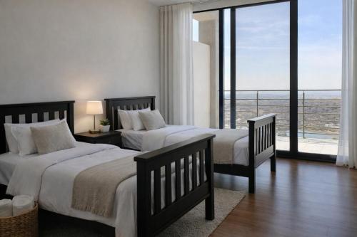 a bedroom with two beds and a large window at Garden views in Juriquilla