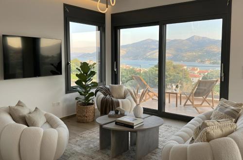 a living room with couches and a table with a view at 360 Skyline Suite, Argostoli in Argostoli
