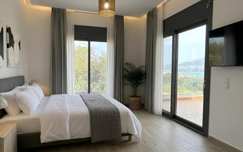 a bedroom with a bed and a large window at 360 Skyline Suite, Argostoli in Argostoli