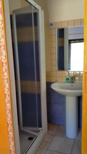 a bathroom with a shower and a sink at Casa Allende in Bosa