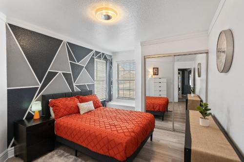 a bedroom with a red bed and a mirror at Private Pool & Fire Pit: Tucson Home Near Hiking! in Tortolita
