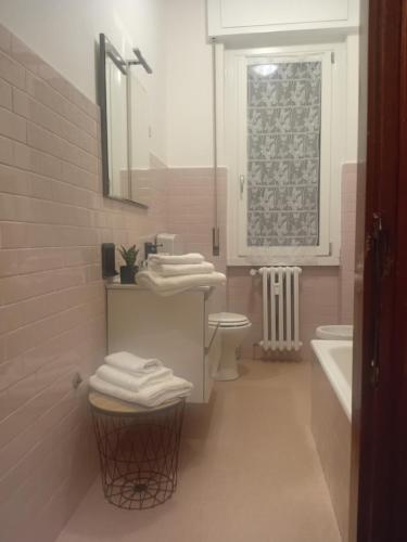 a bathroom with a sink and a toilet and a mirror at Alloggio Veronica in Voghera