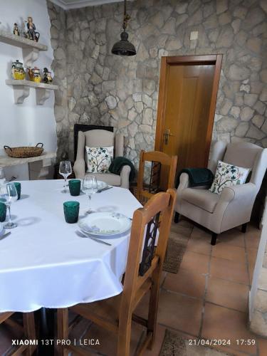 a dining room with a white table and chairs at Casa do Limoeiro - Quartos in Golegã