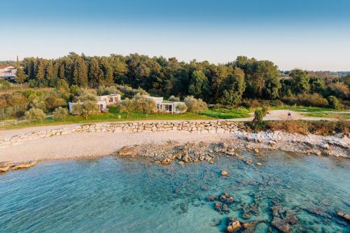 an aerial view of a beach with a body of water at Mobile Homes Sunset Beach in Umag
