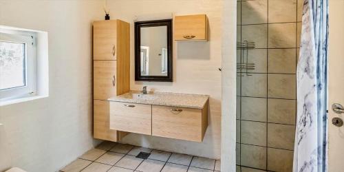 a bathroom with a sink and a mirror and a shower at VE400-Vejers-Strand-Engesovej-52 in Vejers Strand