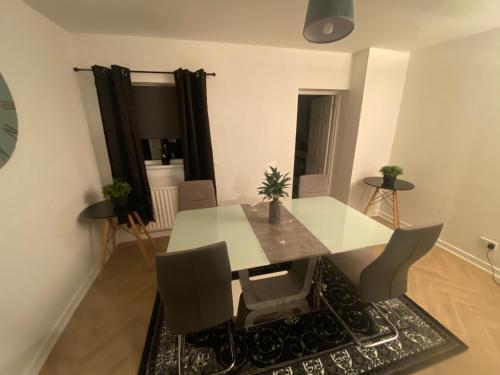 a dining room with a white table and chairs at Alliance house OVER 25 ONLY kids with adults allowed in Belfast