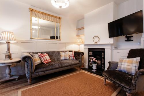 a living room with a couch and a fireplace at Didis Cottage-Dog Friendly-Garden-Cowes-Sleeps 4 in Cowes