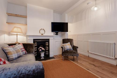 a living room with a couch and a fire place at Didis Cottage-Dog Friendly-Garden-Cowes-Sleeps 4 in Cowes