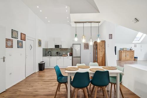 a kitchen and dining room with a table and chairs at Natururlaub Eifel-Mandala Feriewohnung in Kall