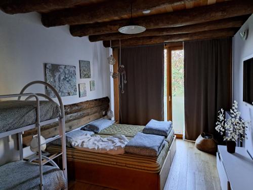 a bedroom with two bunk beds and a window at Ca' Merla affittacamere in Morbegno