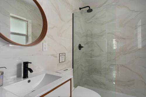 a bathroom with a shower with a sink and a mirror at Spacious w/ 2BR 1Bath - Big Bear in Big Bear City