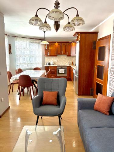a living room with a couch and a table at Apartment VEDA - Апартамент ВЕДА in Veliko Tŭrnovo