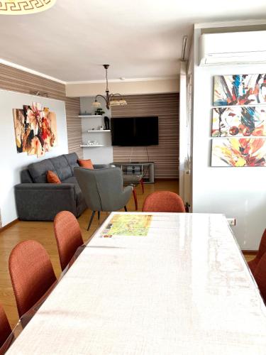 a living room with a table and a couch at Apartment VEDA - Апартамент ВЕДА in Veliko Tŭrnovo