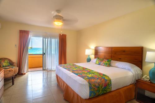 a bedroom with a bed and a view of the ocean at Sugar Bay Club in Frigate Bay