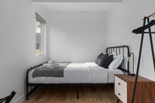 a bedroom with a bed and a white wall at Spacious w/ 2BR 1Bath - Big Bear in Big Bear City