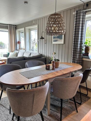 a living room with a wooden table and chairs at Mountain apartment in Vaga