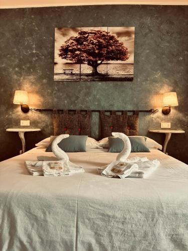 a bedroom with a large bed with swans on it at Fattoria la Cona in Ascoli Piceno