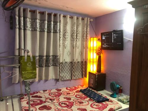 a living room with a curtain and a rug at homestay Huynh DC in Ho Chi Minh City