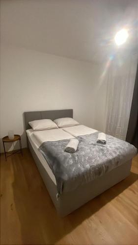 a bed in a bedroom with a light on the ceiling at Aurora Apartment in Vienna
