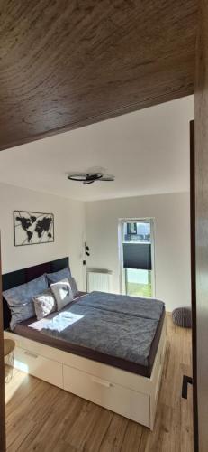 a bedroom with a large bed with a ceiling at Izzy Apartament in Myślenice