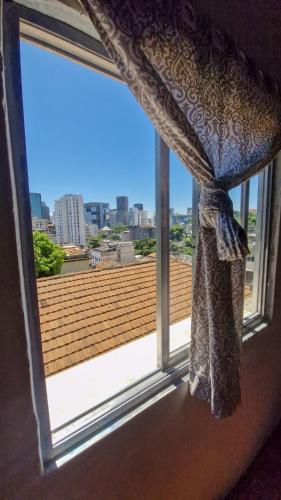 a window with a view of a roof at Carioca Lapa Hostel in Rio de Janeiro