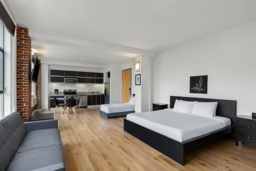 a hotel room with a bed and a couch at The Haas, Trademark Collection by Wyndham in Los Angeles