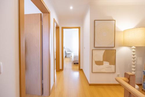a living room with a hallway with a mirror and a door at Cozy Haven Santana - Nature & Hiking Trails in Santana