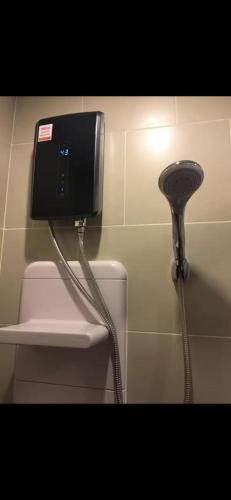 a phone on the wall of a public restroom at Perfectly Located Airport Link Train City Access in Bangkok