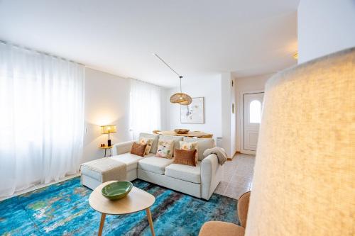 a living room with a couch and a table at Cozy Haven Santana - Nature & Hiking Trails in Santana