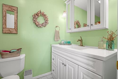 a bathroom with a sink and a toilet at Channel Winds - Waterfront Bliss & Lighthouse Views! in Birch Town
