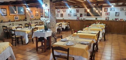 a dining room with tables with yellow tablecloths at ThE MATADOR in Mocejón