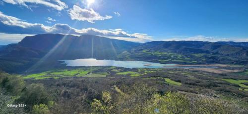 an aerial view of a mountain with a lake at Hostal Centre Del Montsec in Llimiana