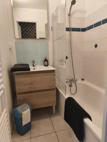 a bathroom with a sink and a tub and a shower at T2 L'orée du Golf labellisé 3 étoiles - Terasse et Parking in Pornic